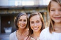 Heed the wisdom of previous generations. Portrait of a grandmother, mother and daughter outside.