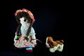 Heel Puppy, let`s go for a walk. Vintage girl rag doll with her puppy; presented on a plain black background.