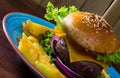 Heeseburger with beef cutlet, fresh vegetables and cheese with french fries Royalty Free Stock Photo