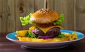 Heeseburger with beef cutlet, fresh vegetables and cheese with french fries Royalty Free Stock Photo