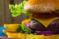 Heeseburger with beef cutlet, fresh vegetables and cheese with french fries