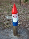 Painted gnome direction sign on a hiking track