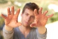 Hefty hard hands. A handsome young man holding up his calloused hands. Royalty Free Stock Photo