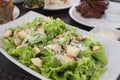 A hefty serving of Caesar salad at an outdoor or al fresco restaurant or cafe