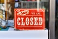 Red retro style `Closed` sign in shopping window
