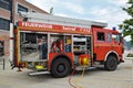 Open red german fire truck with different hoses and fire fight equipment