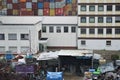Densely packed industrial area with offices, shipping containers, lean to