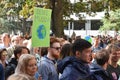 Protest sign saying `Your Mother`in German slang and showing planet earth held up by woman during Global Climate Strike