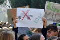 Protest sign with simple drawing of crossed out car and bicycle with green check held up by young people during Fridays for futur