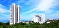 Height white building and small among green tree field with clear blue sky and white cloud background Royalty Free Stock Photo