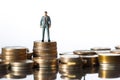 Heights of Success Miniature Man Standing on Money, Illustrating a Business Concept of Comparison and Achievement. created with