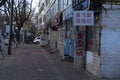 A deserted street in China with many shops and signboards