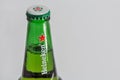 Heineken beer bottle neck closeup against white bacground