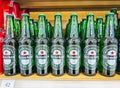 Heineken beer bottles in row,