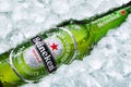 Frosty Heineken beer bottle laying on ice cubes Royalty Free Stock Photo