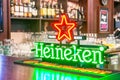 Heineken sign on the bar in the pub. Russia, Sait-Petersburg. 23 April 2019