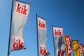 Close up of isolated flags of german Kik fashion discounter chain against clear blue sky