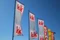 Close up of isolated flags of german Kik fashion discounter chain against clear blue sky