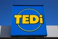 Close up of isolated sign of german Tedi non-food textile discounter chain against clear blue sky