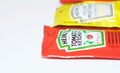 Ketchup and mustard from Heinz brand in sachets Royalty Free Stock Photo