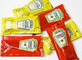 Ketchup and mustard from Heinz brand in sachets Royalty Free Stock Photo