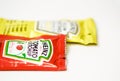 Ketchup and mustard from Heinz brand in sachets Royalty Free Stock Photo