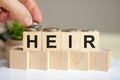 heir letters written on wooden toy blocks, business concept