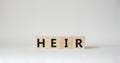 Heir symbol. Concept word Heir on wooden cubes. Beautiful white background. Business and Heir concept. Copy space