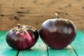 Heirloom fresh organic eggplants on turquoise background