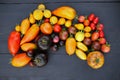 Heirloom tomatoes collection on black wooden background Royalty Free Stock Photo