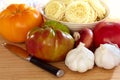 Heirloom Tomatoes, Onion, Garlic, Pasta and Knife Royalty Free Stock Photo