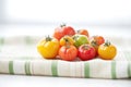 heirloom tomatoes piled on a white cloth Royalty Free Stock Photo