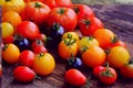 Heirloom variety tomatoes on rustic table. Colorful tomato - red,yellow , black, orange. Harvest vegetable cooking conception Royalty Free Stock Photo