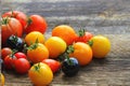 Heirloom variety tomatoes on rustic table. Colorful tomato - red,yellow , black, orange. Harvest vegetable cooking conception