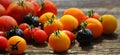 Heirloom variety tomatoes on rustic table. Colorful tomato - red,yellow , black, orange. Harvest vegetable cooking conception