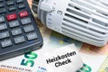 Heizkosten prÃÂ¼fen. Konzept mit Heizthermostat, Taschenrechner und Euro Banknoten