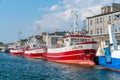 Hel, Poland - 08.01.2021: Line of red and white fishing boats docked at the pier on a sunny summer day with port Royalty Free Stock Photo