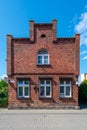 Hel, Poland - 08.01.2021: Vertical shot of exterior of traditional, old, red brick, two store solitaire building in the