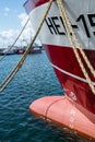 Hel, Poland - 08.01.2021: Vertical wide shot of red and white fishing boat tied to pier on a beautiful sunny summer day Royalty Free Stock Photo