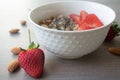 Helathy vegan oatmeal porridge with strawberries, chia seeds and sliced almonds