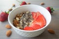 Helathy vegan oatmeal porridge with strawberries, chia seeds and sliced almonds