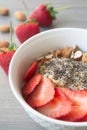 Helathy vegan oatmeal porridge with strawberries, chia seeds and sliced almonds