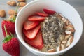 Helathy vegan oatmeal porridge with strawberries, chia seeds and sliced almonds