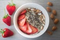 Helathy vegan oatmeal porridge with strawberries, chia seeds and sliced almonds