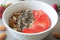 Helathy vegan oatmeal porridge with strawberries, chia seeds and sliced almonds Royalty Free Stock Photo