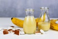 Helathy yellow banana and coconut smoothie drink in jars