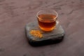 Helba drink or fenugreek yellow tea on wooden board on brown background. Methi Dana drink. Herbal tea. Alternative medicine Royalty Free Stock Photo