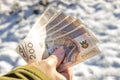 Held in hand Polish money, 200 zlotys banknotes, On the background of snow. The concept of inflation and price increases with the Royalty Free Stock Photo