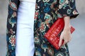 Helena Bordon poses for photographers with red Chanel bag before Rochas show, Paris Fashion Week