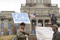 Helena, Montana - April 19, 2020: A man protesting wearing a hat carrying a science is not my religion sign at a Coronavirus